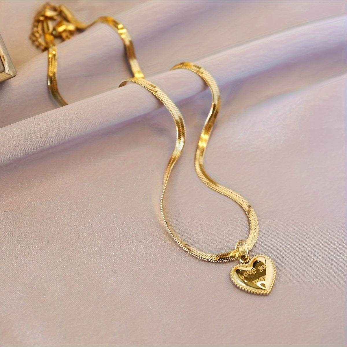 Stylish Heart Pendant Snake Chain Necklace for Women, featuring 18K Gold Plating and sleek 316 Stainless Steel. Perfect for everyday wear or as a thoughtful gift. This necklace does not have any stone inlay.