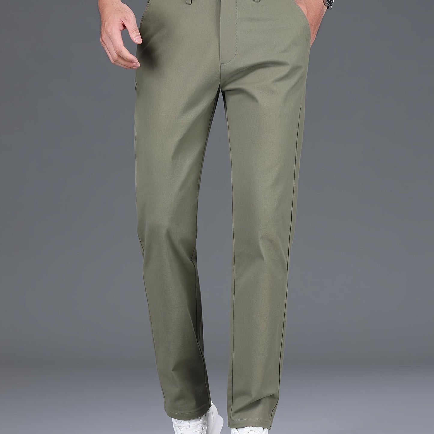 Men's slim-fit cotton blend trousers in solid color, suitable for business casual wear throughout the year. Features micro-elastic fabric, pockets, and regular length.