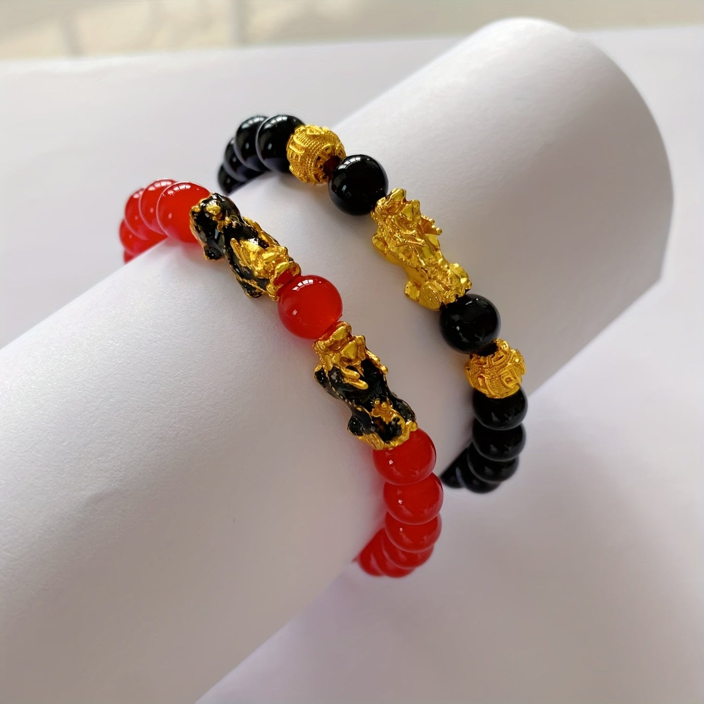 Two Pixiu bracelets, one in red antique style, offering a safe and lucky accessory. This classic, luxurious piece symbolizes prosperity and is beautifully crafted with shiny, artificial jewels. Perfect for gifting to girlfriends, sisters, or mothers to