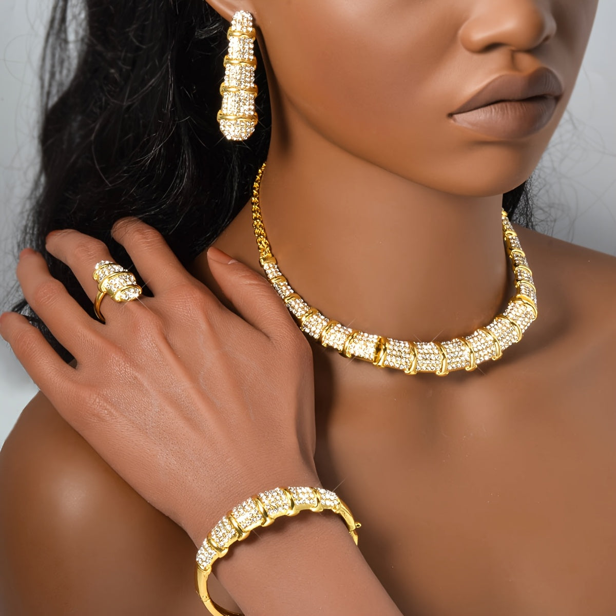 An elegant jewelry set designed for women, featuring a stunning bamboo-shaped necklace, bracelet, earrings, and ring. This four-piece set is perfect for sophisticated women attending weddings or as a luxurious holiday gift.