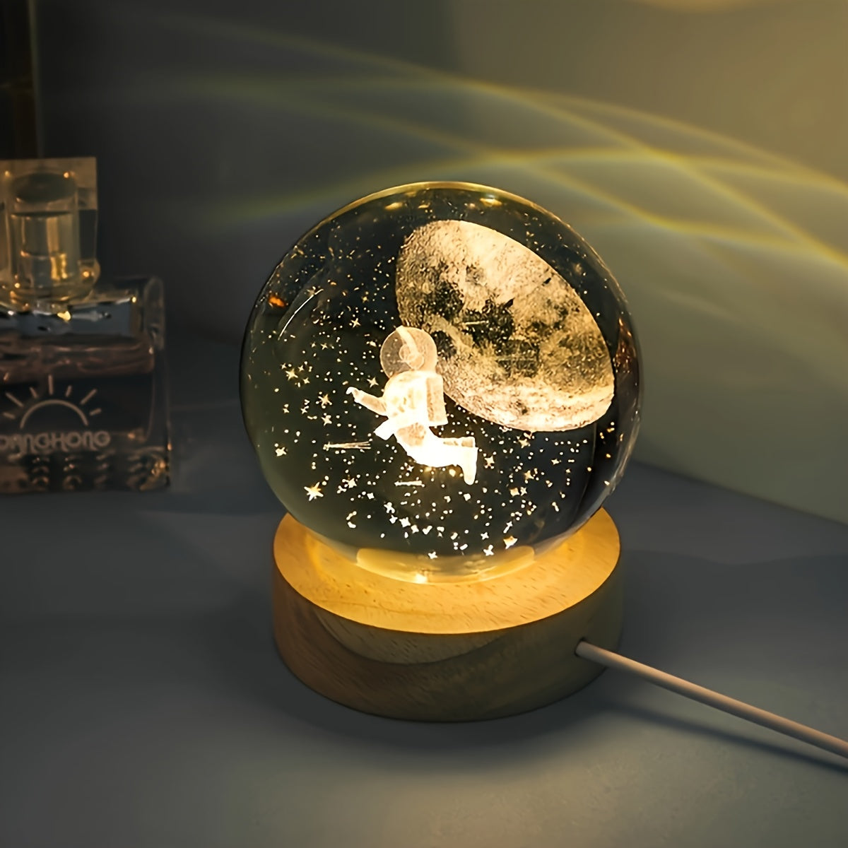 One 3D laser engraved crystal ball night light featuring the solar system and Saturn, powered by USB for home and office decoration, and makes a special gift for Valentine's Day, Christmas, or birthdays.