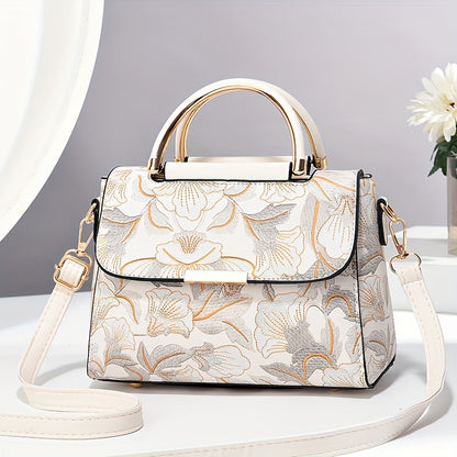 Large capacity floral embroidered crossbody bag with zipper closure and polyester lining. Versatile commuter handbag with luxurious, fashionable design and edge paint detail. Available in