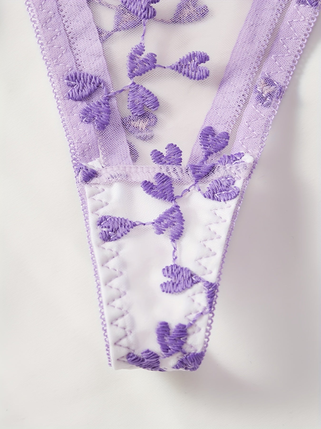 Purple mesh lingerie set with heart embroidery, bow decor, semi-sheer bra and tie side thong. Women's sexy underwear.