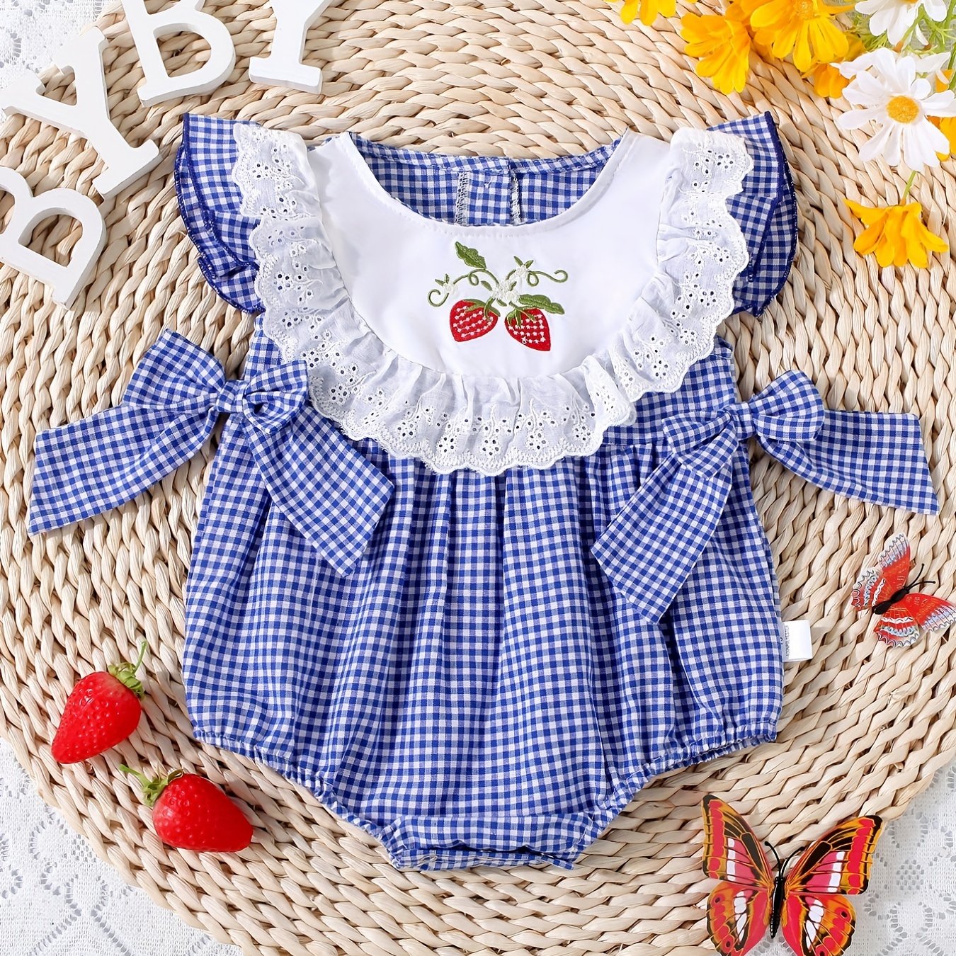 Infant girls' plaid onesie with strawberry embroidery and bow details, suitable for casual outdoor wear.