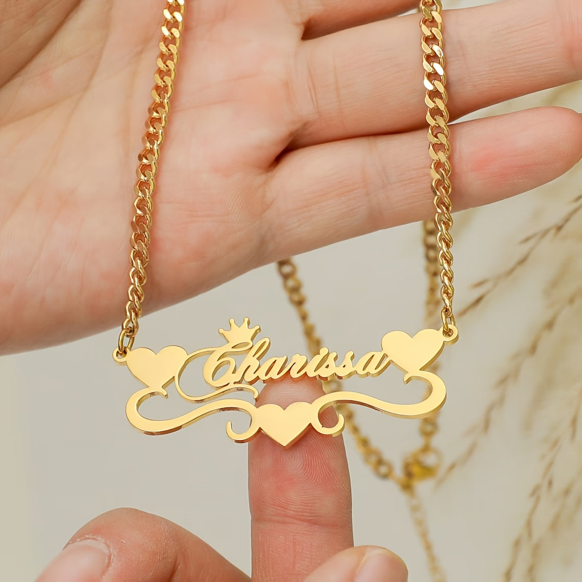 A single elegant custom 4MM Cuban link chain necklace with personalized name pendant, featuring a stainless steel heart ribbon plaque. This fashion crown jewelry for women is a versatile daily accessory suitable for all-season wear.