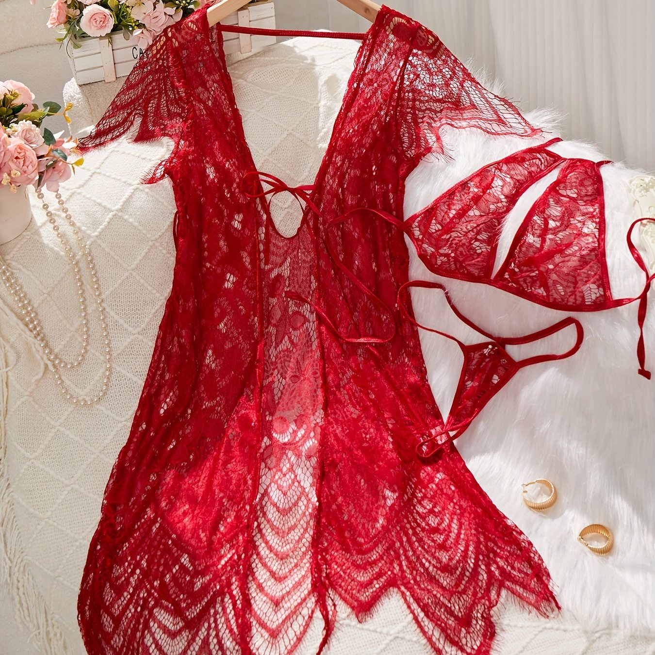 Lace lingerie set with belt and cardigan, bra, and thong for women.