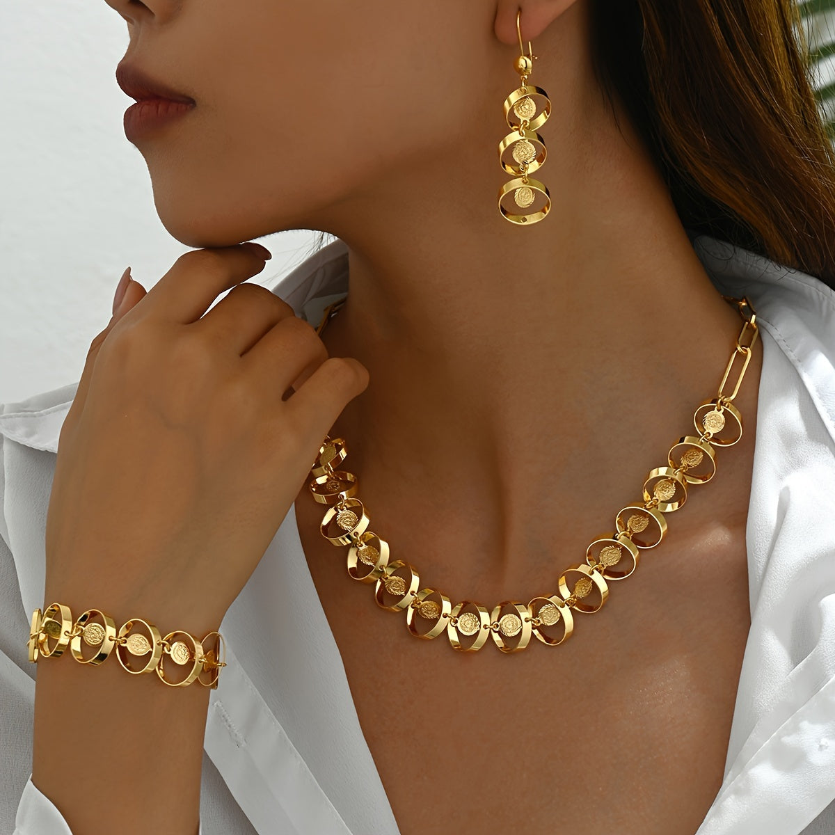 Set of four exquisite and elegant vintage-inspired women's jewelry pieces in 18K gold plating, perfect for a fashionable banquet. Includes a necklace, earrings, bracelet, and ornament.