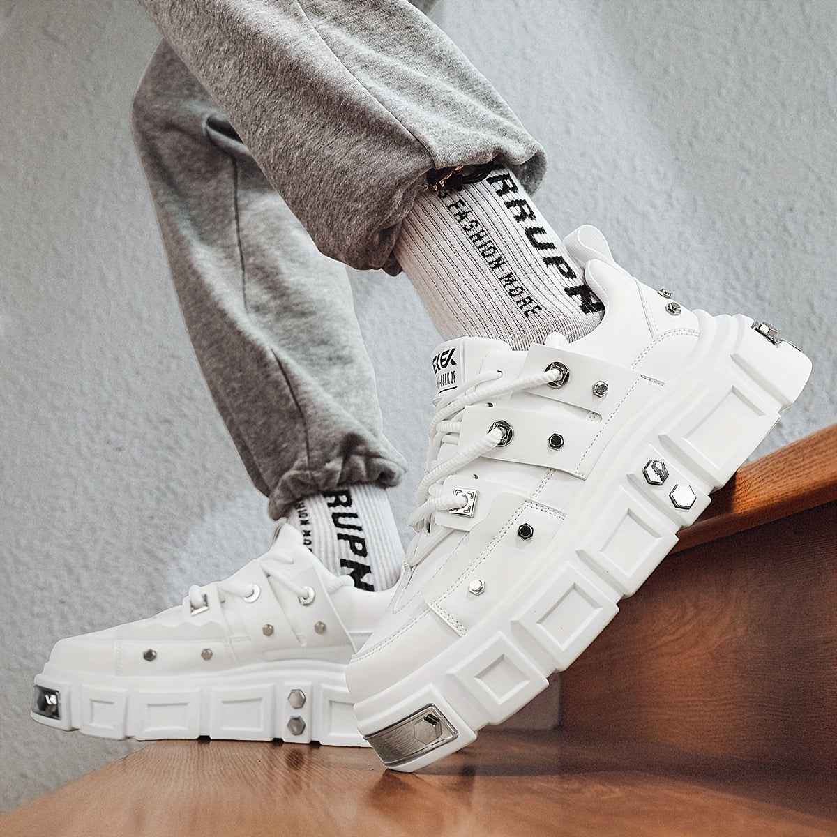 Chunky, punk-inspired sneakers with metal stud accents. Streetwear fashion statement in white, thick-soled trainers. Ideal for skateboarding, parties, and everyday wear. Unisex.