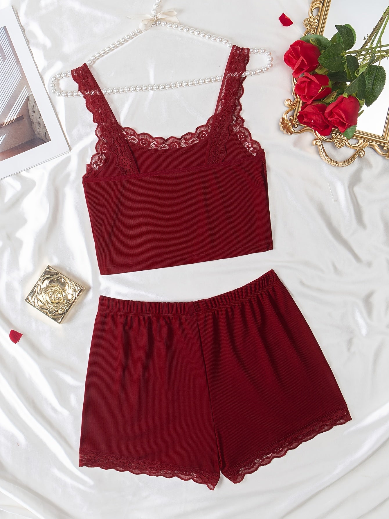 Women's loungewear set includes lace trim cami top and elastic waistband shorts.