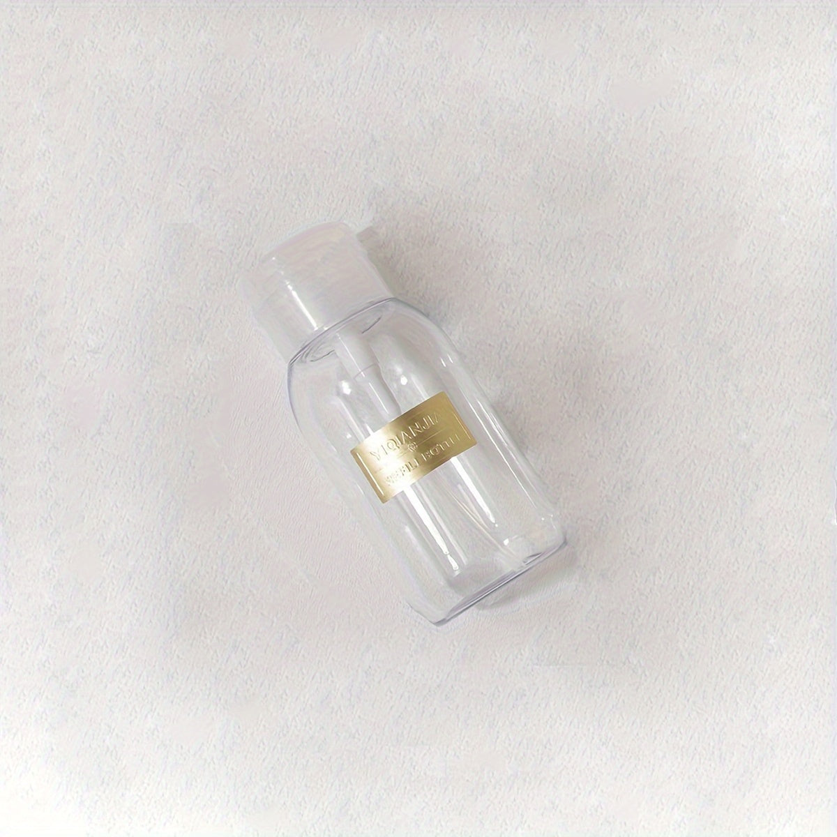 A portable push down empty bottle for dispensing nail polish or makeup remover.