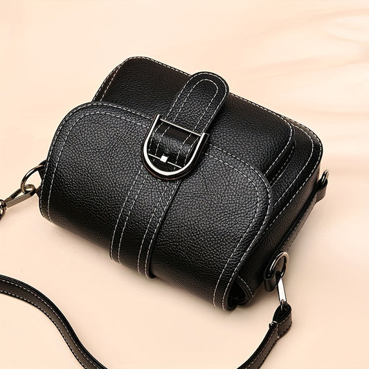 Small solid color crossbody bag with buckle decor and flap closure for everyday use.