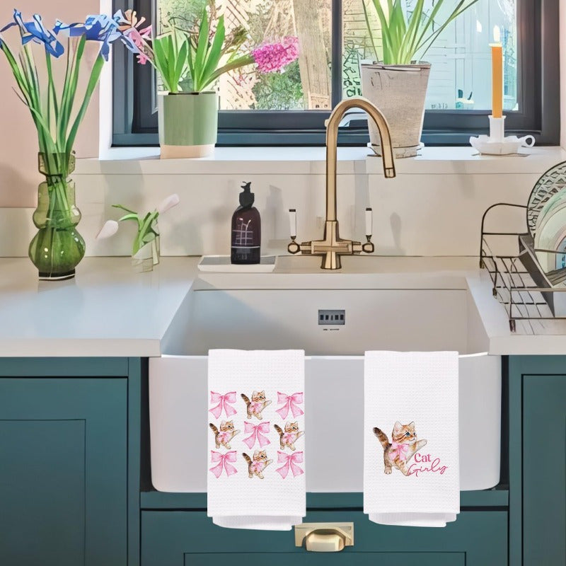 Set of two adorable pink cat hand towels made of highly absorbent microfiber, perfect for kitchen and dishwashing tasks. Featuring a cute cat and bow design, this set makes an ideal gift for cat lovers and moms. Each towel measures approximately