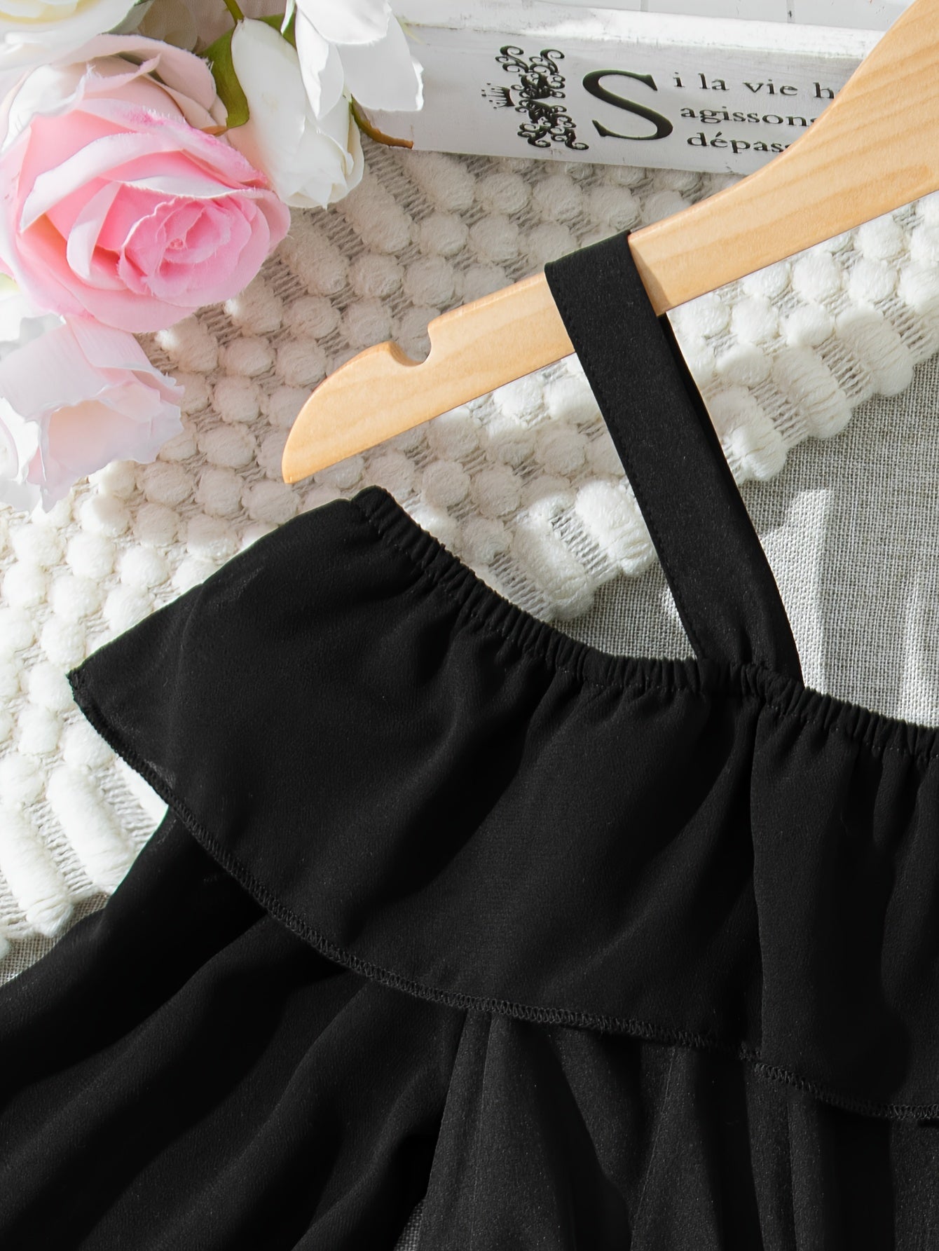 Black chiffon dress with off-shoulder ruffle detail, perfect for casual summer style.