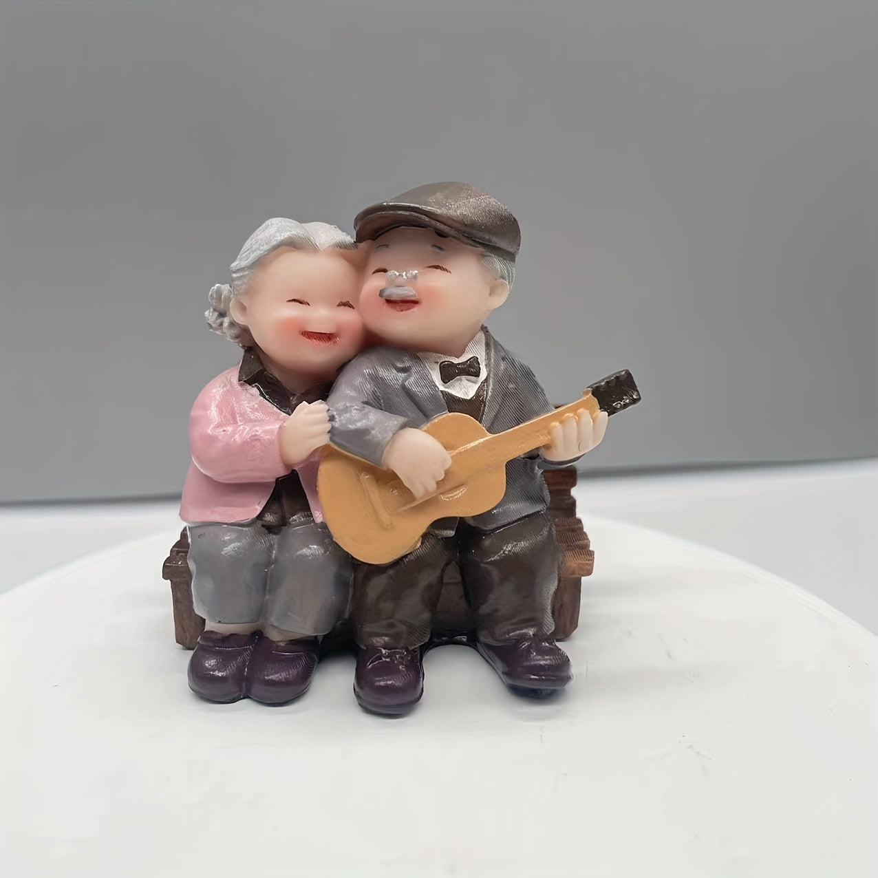 Resin figurine of charming elderly couple, ideal for home or office decor. Perfect Valentine's Day or anniversary gift.