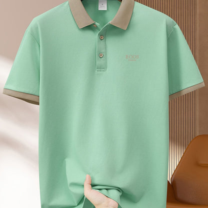 Men's light green casual polo shirt with contrast trim made of comfortable polyester. Features short sleeves, button-up collar, and a fun graphic design. Ideal for summer golf and sports