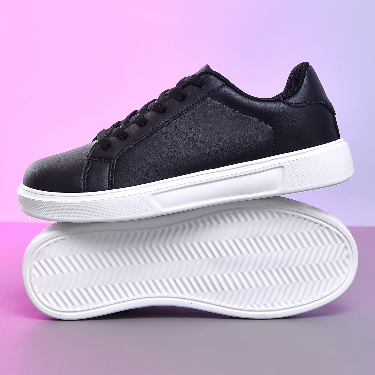 Black lace-up sneakers for women, versatile and comfortable for outdoor activities.