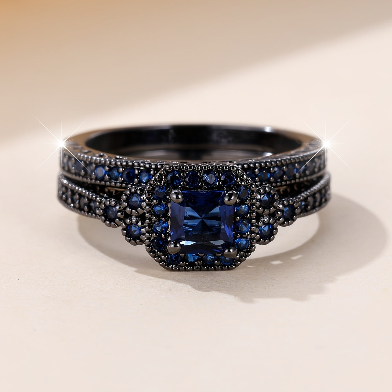 Set of 2 elegant promise rings featuring a halo ring with a dark blue zirconia stone and an eternity ring, perfect for engagement or wedding jewelry. Ideal for brides to enhance their evening party attire.