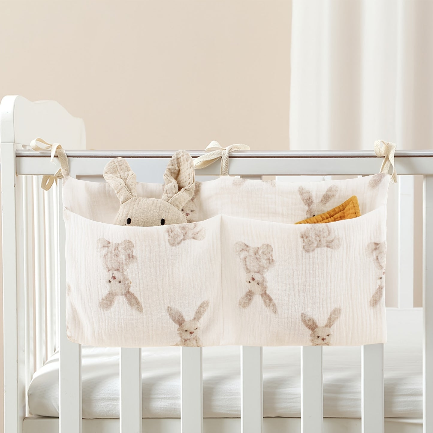 Double-layer fabric hanging storage bag with two stroller pockets, ideal for holding baby bottles with printed patterns.