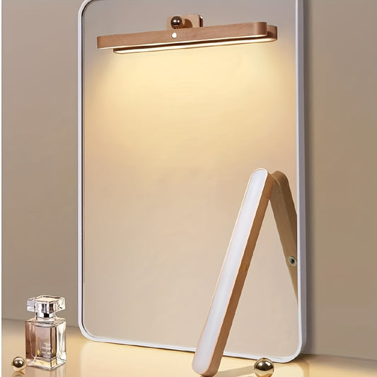 Portable, rechargeable LED night light with wooden frame and mirror front. Can be mounted on a wall magnetically. Ideal for bedroom or bedside use.