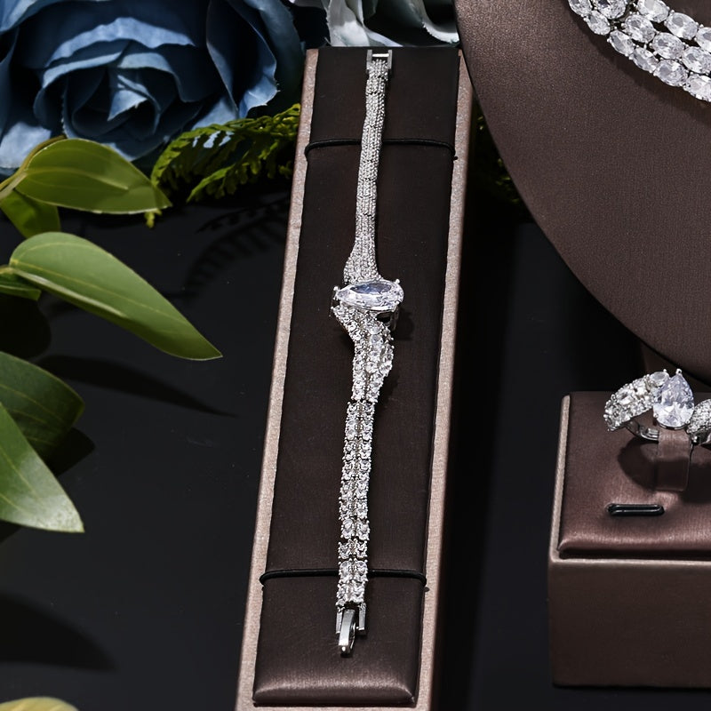 Indulge in the opulence and sophistication of this exquisite women's jewelry set, perfect for weddings, holidays, and everyday wear. This stunning ensemble includes a bracelet, necklace, ring, and earrings, each embellished with dazzling Zirstones and