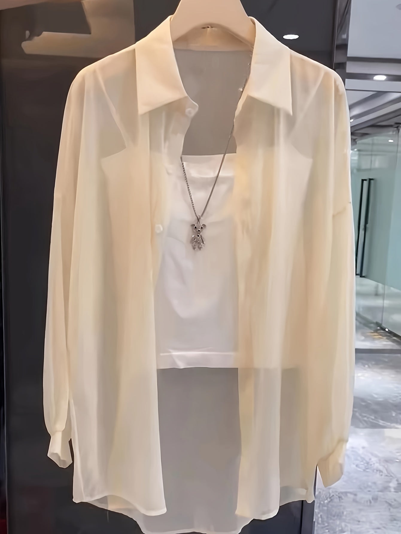 Casual women's shirt with buttons, sheer long sleeves for spring and fall.