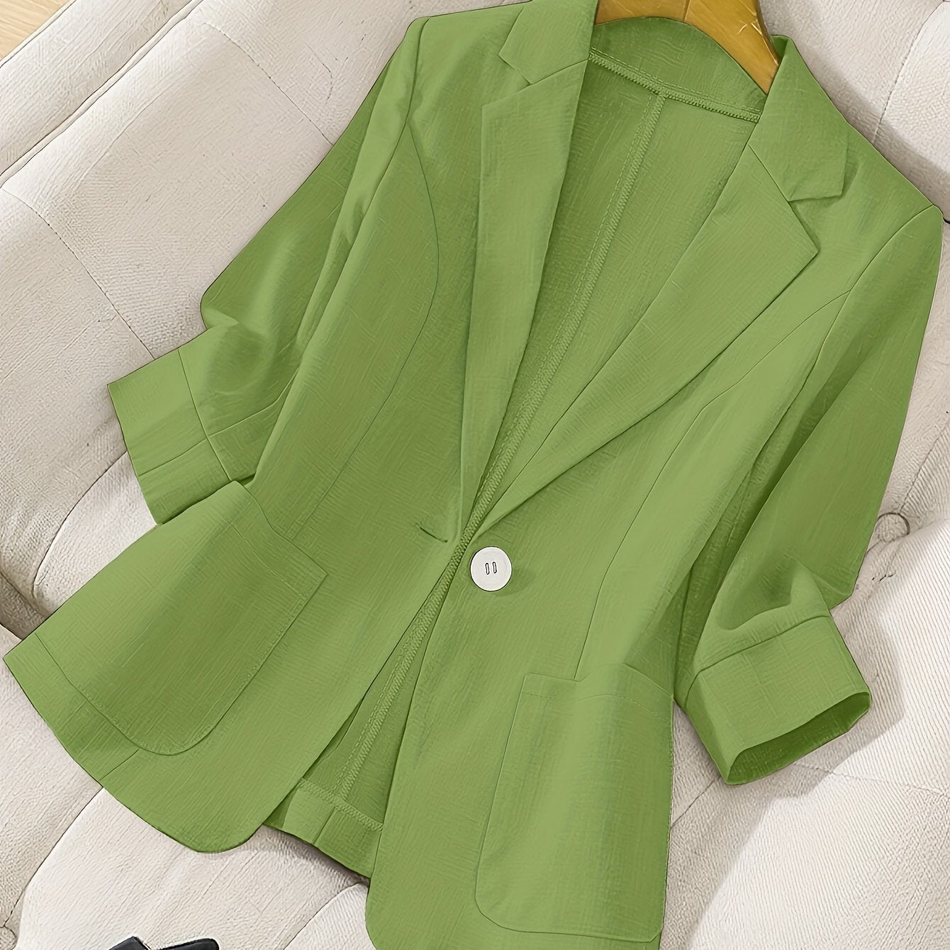 Women's lime green fashion blazer is single-breasted and made of lightweight polyester. Features a classic collar, two flap pockets, and a straight cut for spring/summer elegance.