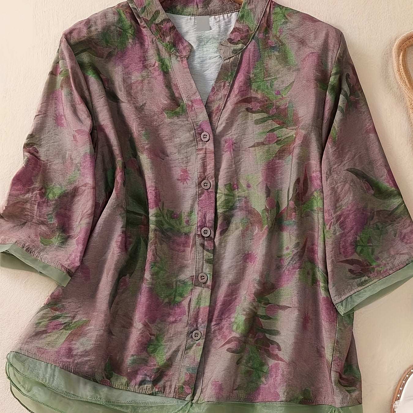 Women's floral print shirt with high neck, three-quarter sleeves, and cross hem. Made of polyester in a regular fit for weekend wear.