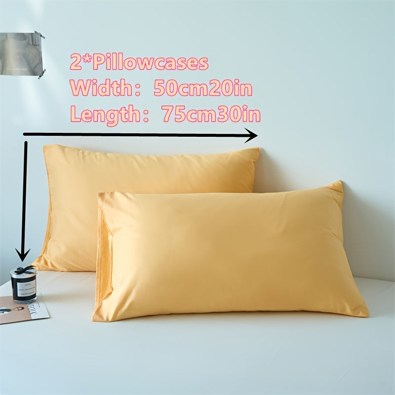 Two polyester pillowcases for bedroom use, featuring a multi-colored solid design.