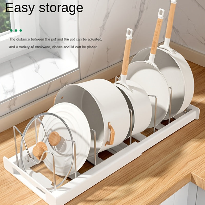 Retractable pot rack for kitchen storage, built into the cabinet under the sink. This adjustable rack is designed to store pots, pans, and lids, making it a convenient kitchen accessory.