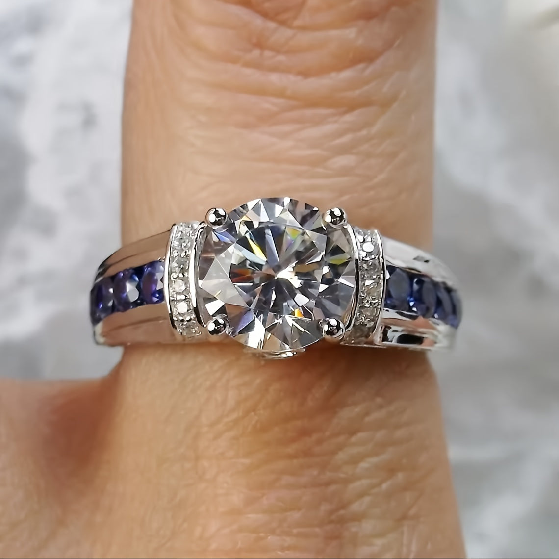 Beautiful 2ct Moissanite Engagement Ring adorned with stunning Blue Side Stones, crafted in 925 Sterling Silver Plating. This Boho Royal Style ring is ideal for both daily wear and special festival celebrations, making it a wonderful Mardi Gras gift.