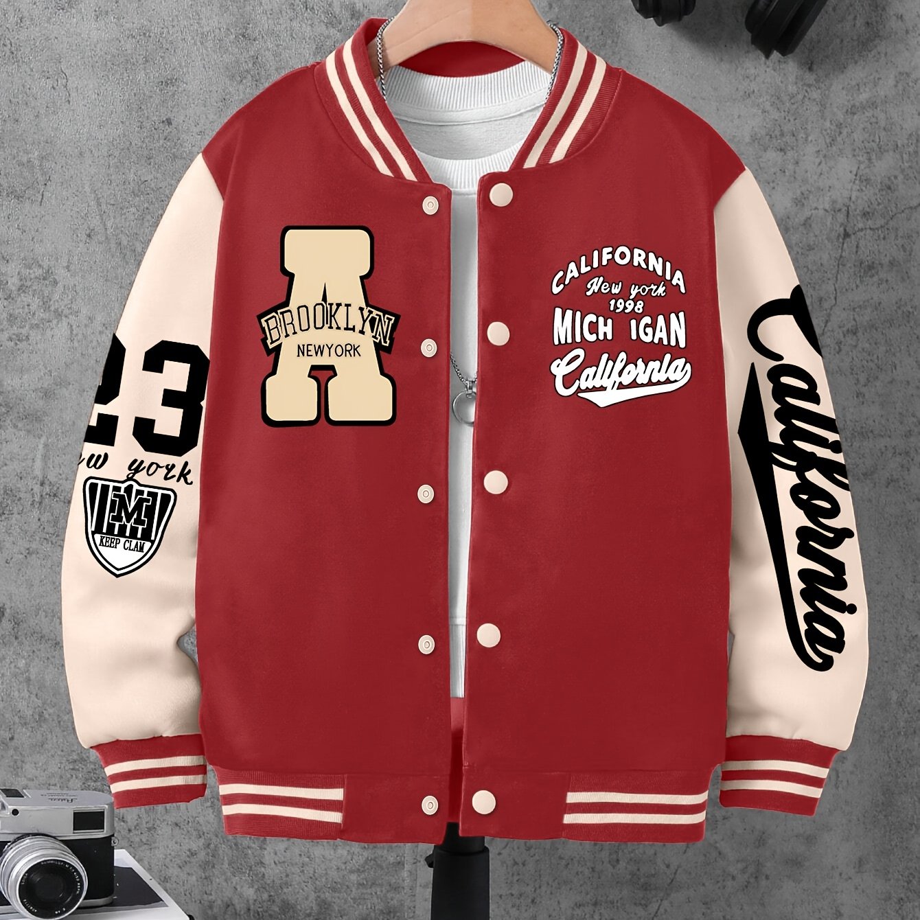 Boys' polyester varsity jacket with geometric pattern and baseball collar, featuring letter A and number 23 print.