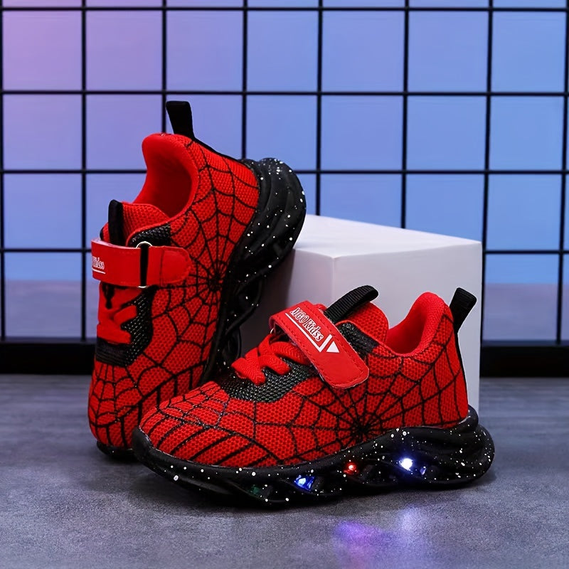 Durable rubber-soled boys' LED sneakers in red and blue with spider web design, breathable mesh, and hook-and-loop closure for casual wear and playtime.