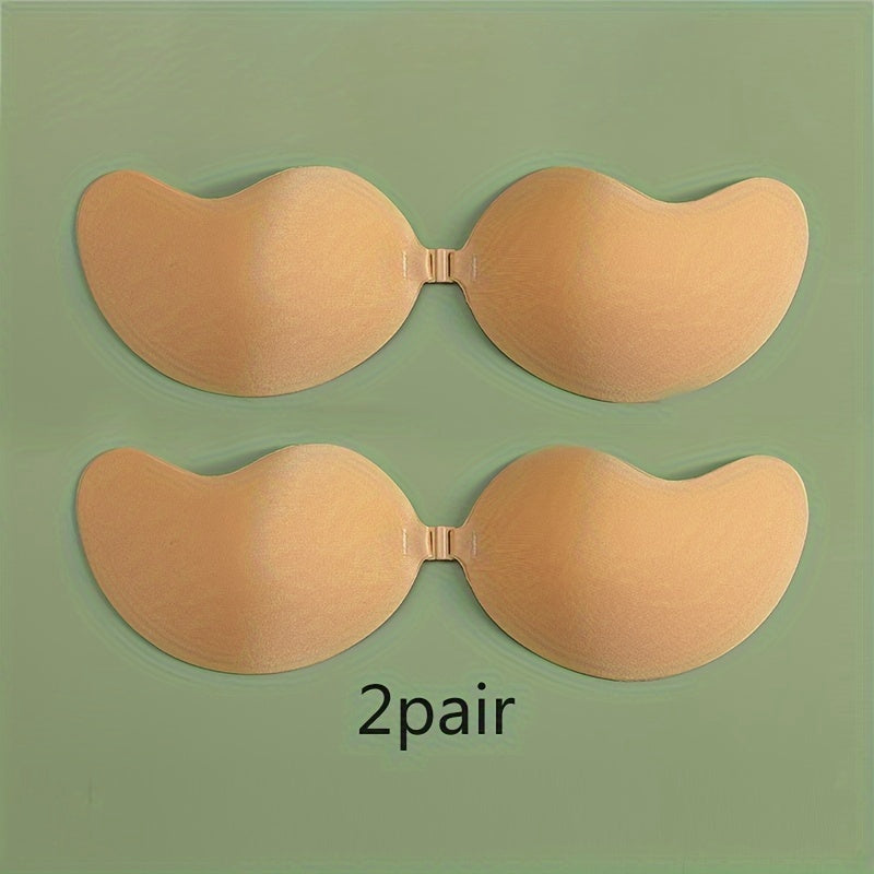 2 pairs of self-adhesive, strapless lifting bras with slip-proof design for women. Mango shaped straps, polyester & silicone blend. Hand wash only. Ideal for vests & dresses.