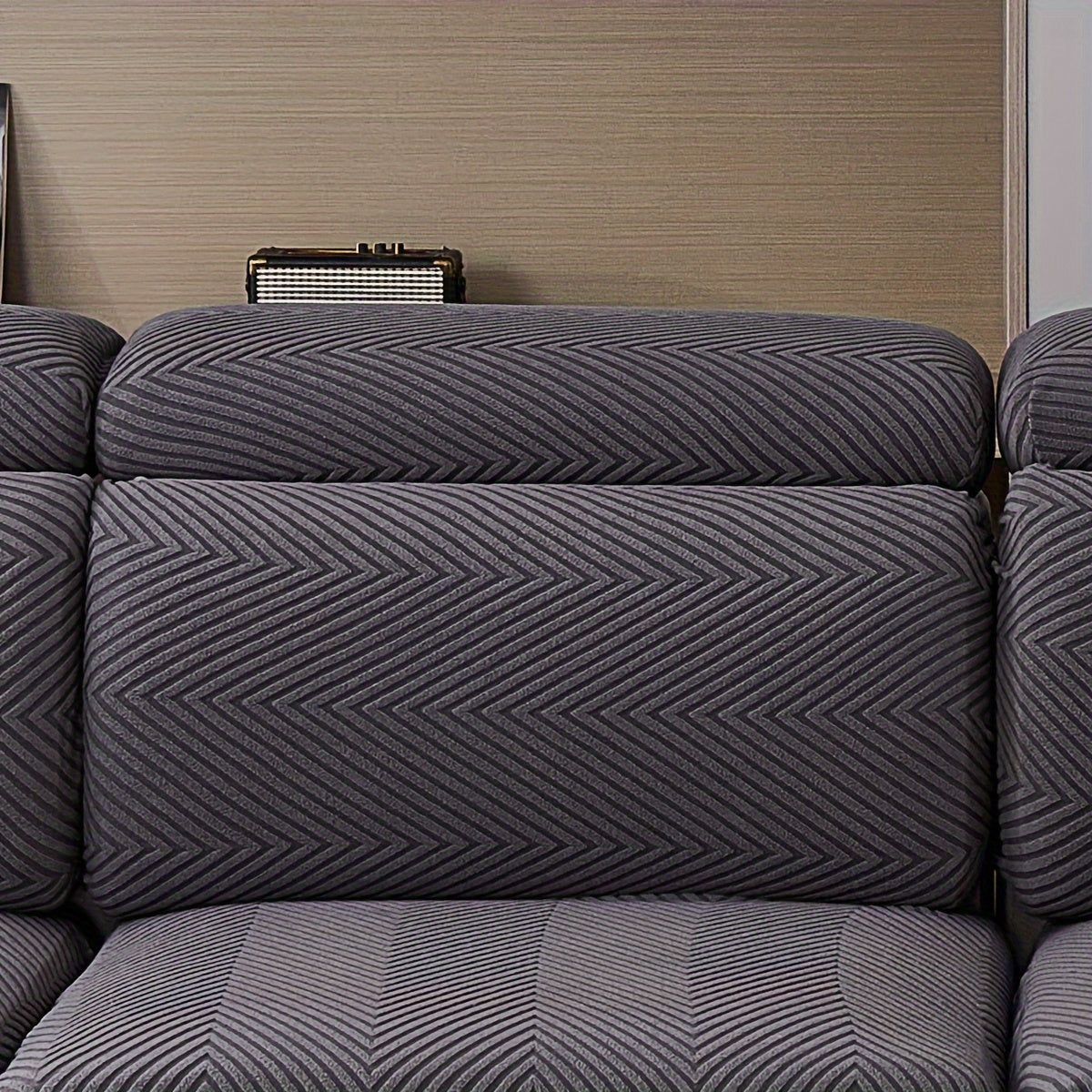 Waterproof sofa cover with elastic stretch and jacquard argyle pattern for home or office decor.