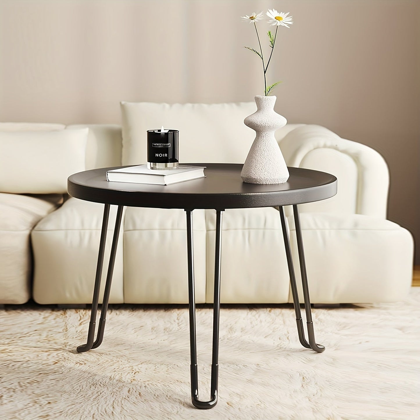 Compact and modern, this small round folding coffee table features a tray surface supported by three legs. Ideal for use as a bedside table in bedrooms and living rooms, this piece is perfect for compact spaces.