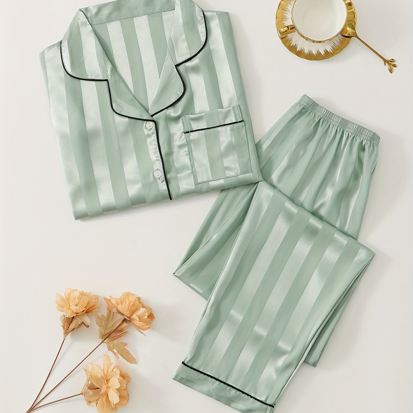 Women's satin pajama set with striped long sleeve top and lounge pants for sleepwear and loungewear.