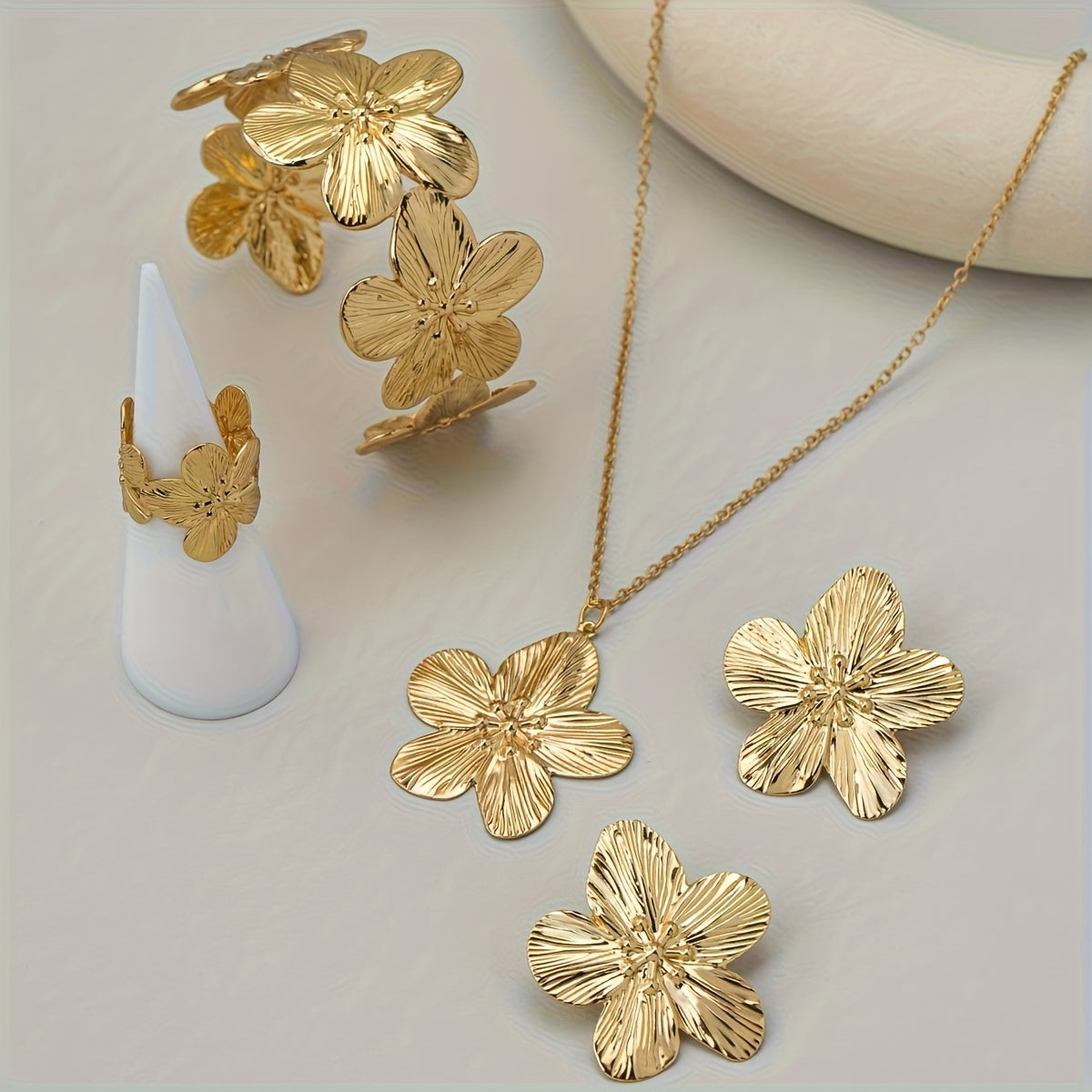 Set of 5 stylish and beautiful floral jewelry pieces including earrings, rings, bracelets, and necklaces.