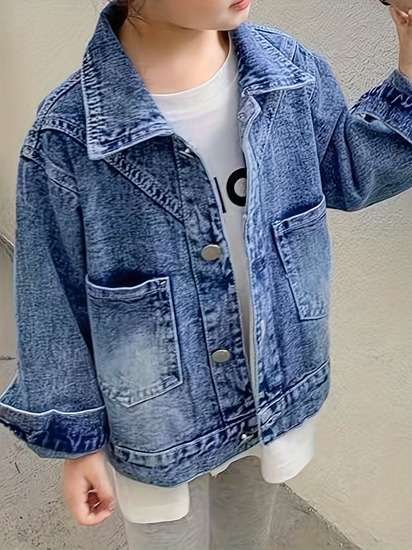 Children's loose fit denim jacket for girls, made from soft fabric.