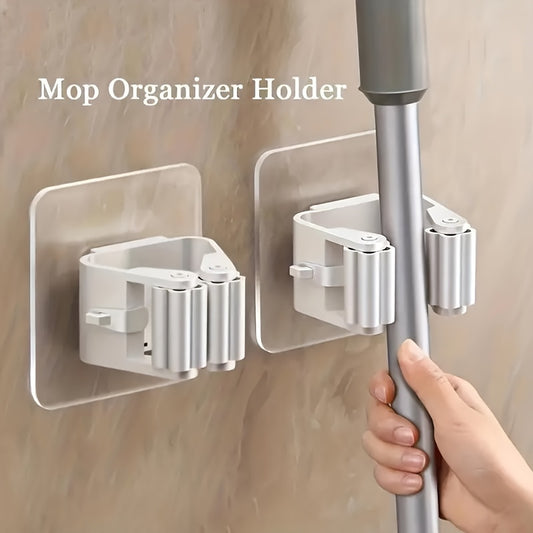 Wall-mounted ABS mop holder with 4 clips for easy and drill-free installation, featuring strong adhesive hooks for bathroom storage.