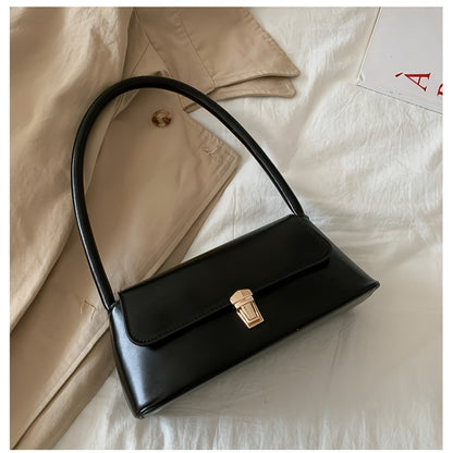 Chic black shoulder bag for women with French-inspired design and golden clasp. Versatile and stylish for everyday use with neat stitching detail.