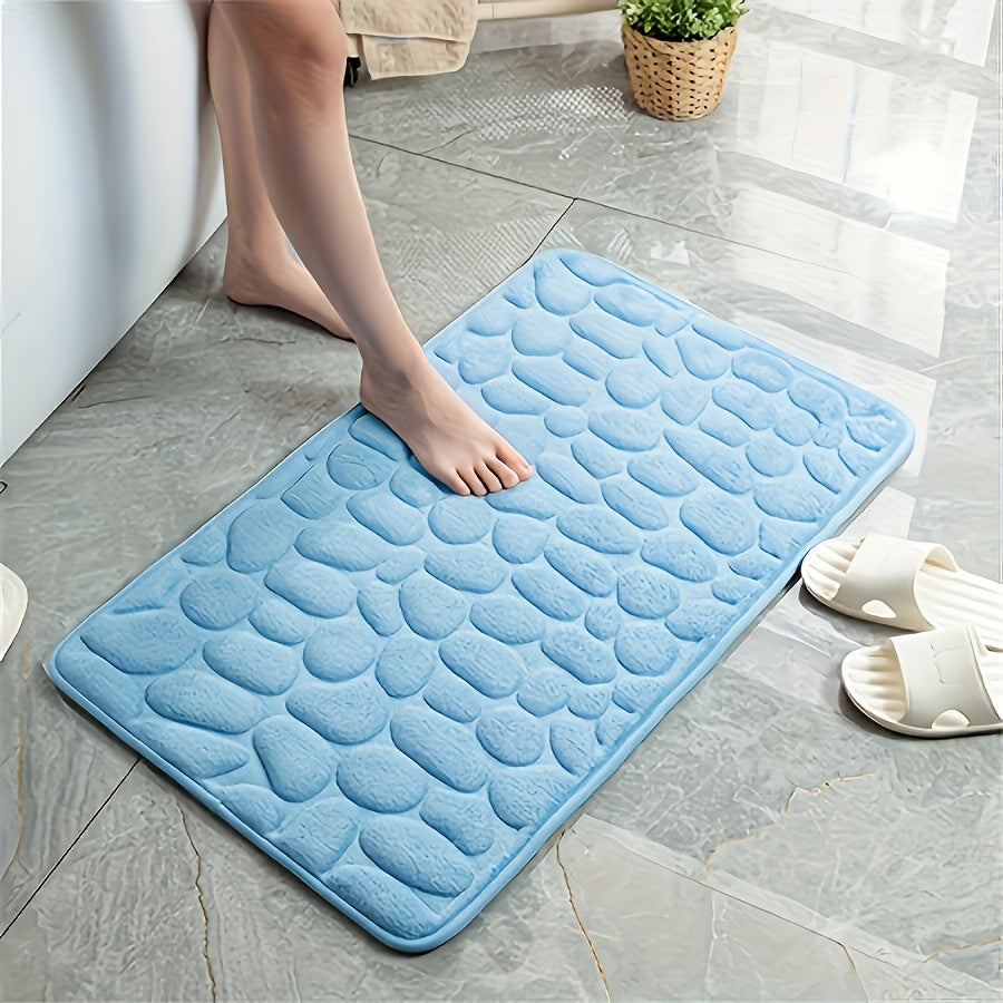 One piece of bath mat with embossed pebble pattern, highly absorbent and non-slip for bathroom use. Suitable for tub, toilet, and floor, made of machine washable polyester material. Dimensions are 59.94x39.88 cm.