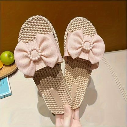 Women's PVC slip-on sandals with bow and bead accents, flat heel, open toe, ideal for beach wear.  Bow embellished, made from synthetic material.