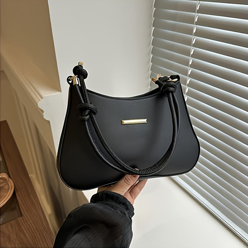 Black square handbag with zipper closure, crossbody style, edge paint detail.