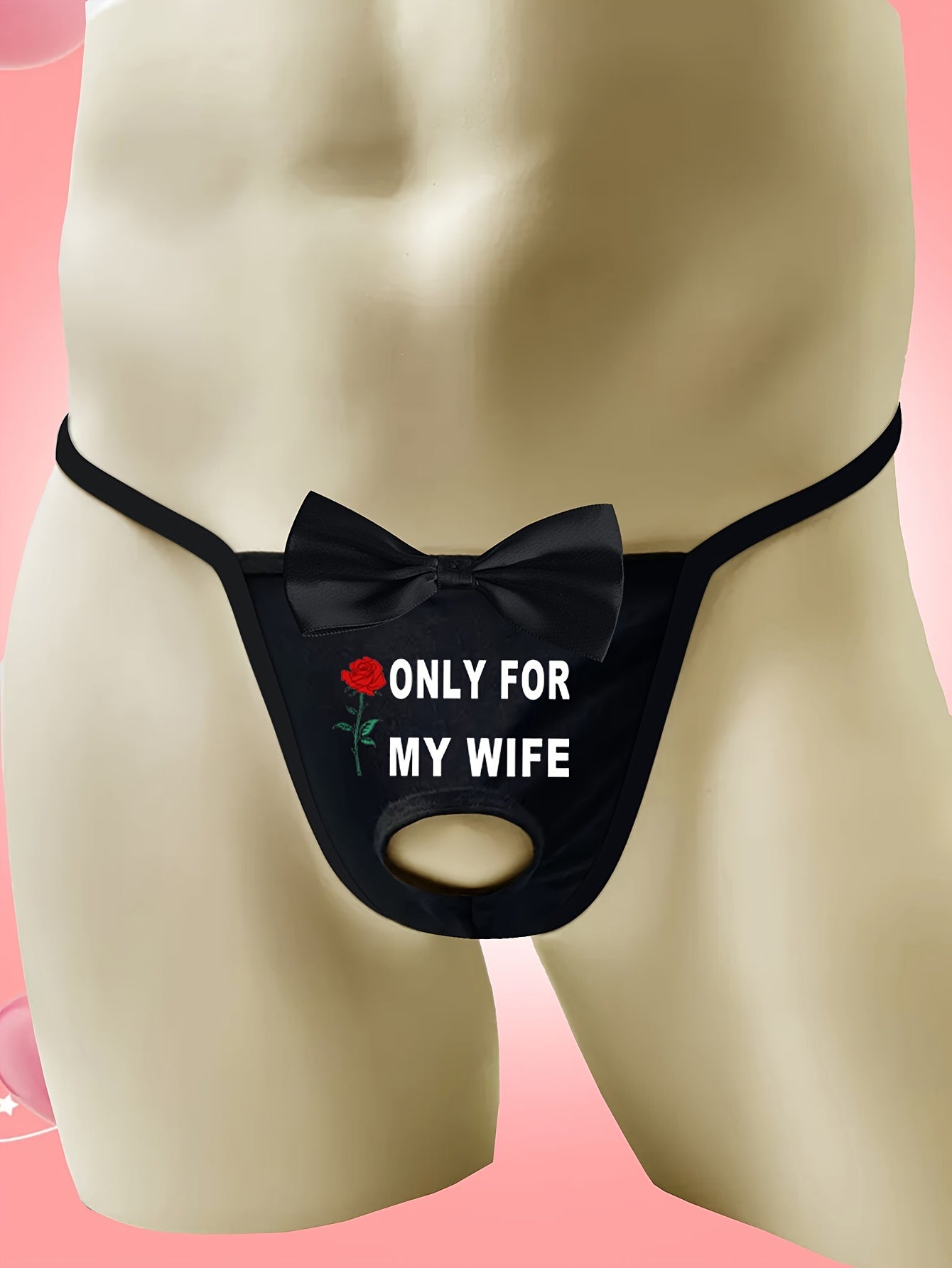 Men's sexy black thong with front cut-out and bow detail, featuring "ONLY FOR MY WIFE" red rose print. Made with comfortable, breathable polyamide (90%) and elastane (10%) knit fabric.