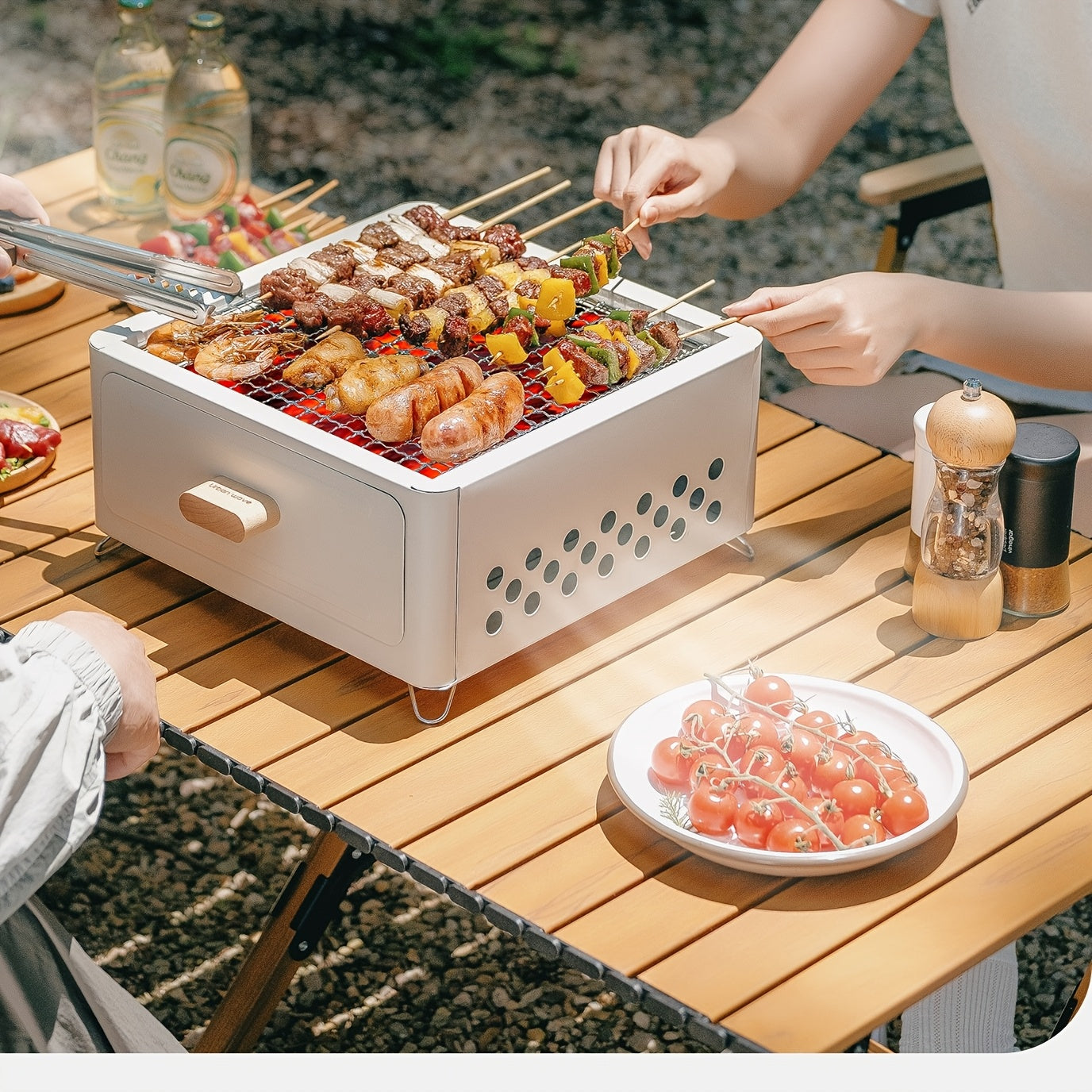 Square portable indoor barbecue grill set made of durable metal materials, with detachable legs and cooking rack, featuring an ash pan. Lighter not included. Ideal for home use.