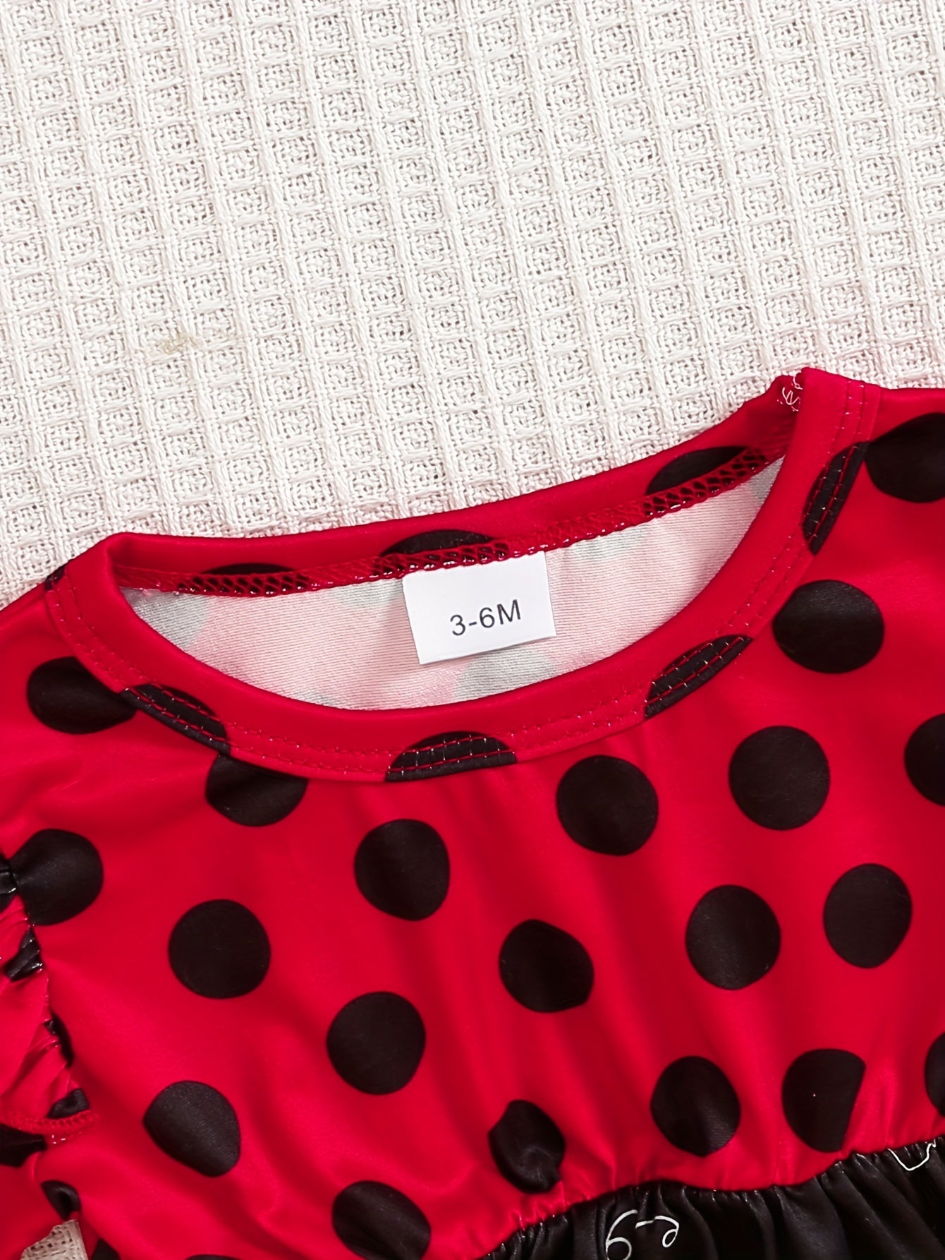 Ladybug print polyester toddler outfit with long sleeve crew neck pullover, matching pants, and headband. Made from slight stretch knit fabric for fall/winter. Regular fit raglan sleeve