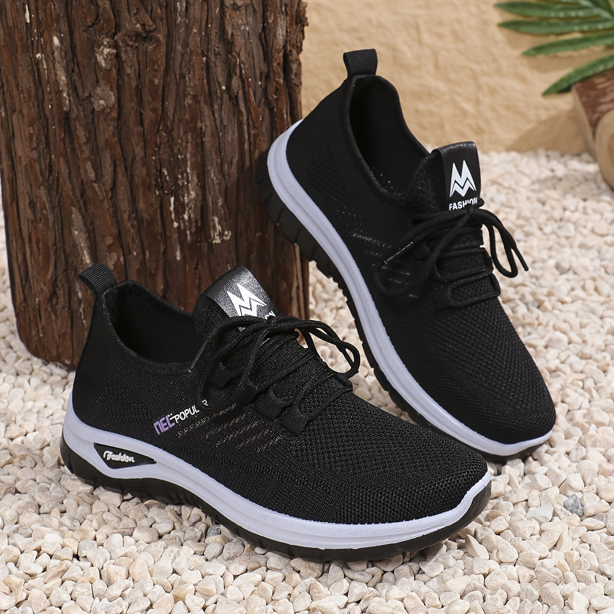 Black knit mesh sneakers with lace-up closure, dual-layer sole, and easy slip-on design for daily commute and outdoor activities. Sleek, breathable and perfect for daily wear.