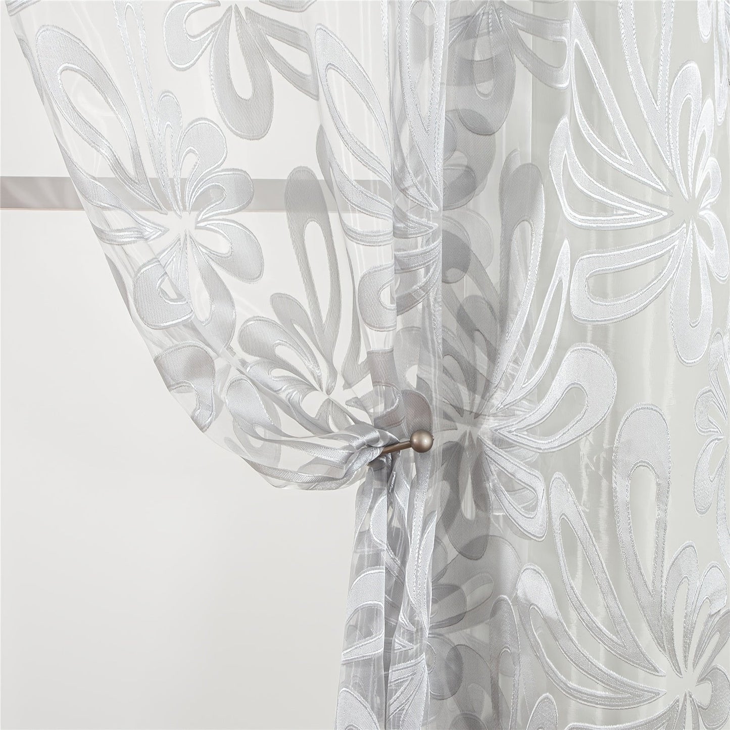 This Elegant Geometric Sheer Curtain Panel in Brown & White Floral Jacquard Design is made of lightweight polyester. It is machine washable and comes with eyelets for easy hanging. Ideal for enhancing the decor of your living room or bedroom.