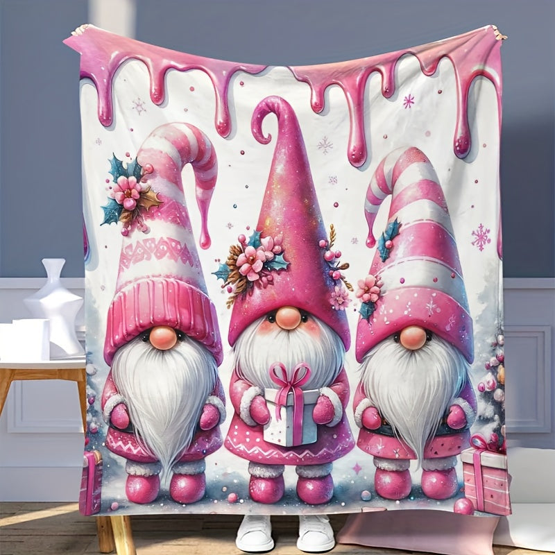 Soft, warm, and versatile flannel throw blanket featuring a cozy Christmas gnome and bell print. Perfect for snuggling on the couch, adding warmth to your office chair, staying cozy in bed, camping under the stars, or traveling in style. This all-season