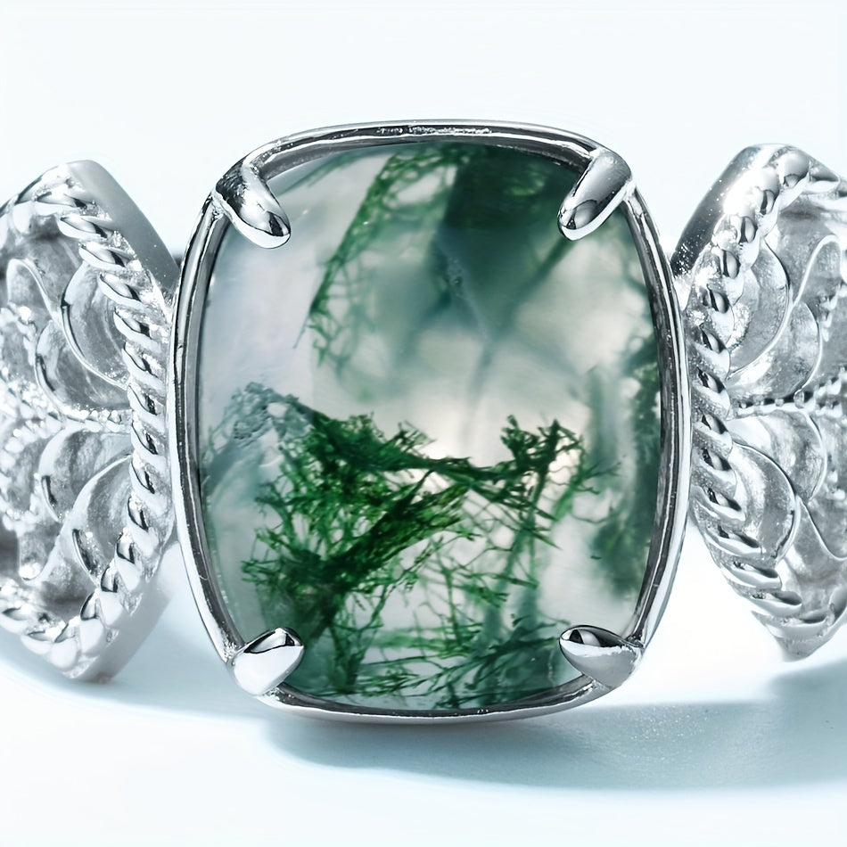 The Vintage-Inspired Green Moss Agate Open Ring is a timeless piece made with 2.4CT of stunning green moss agate set in S925 sterling silver. This elegant ring is perfect for both daily wear and gifting. Featuring a unique water grass design, the stone